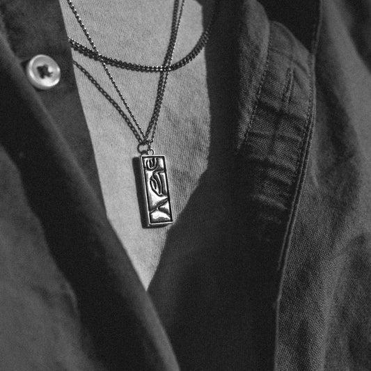 Solaque Silent Gaze handmade sterling silver face design pendant jewellery worn by a person