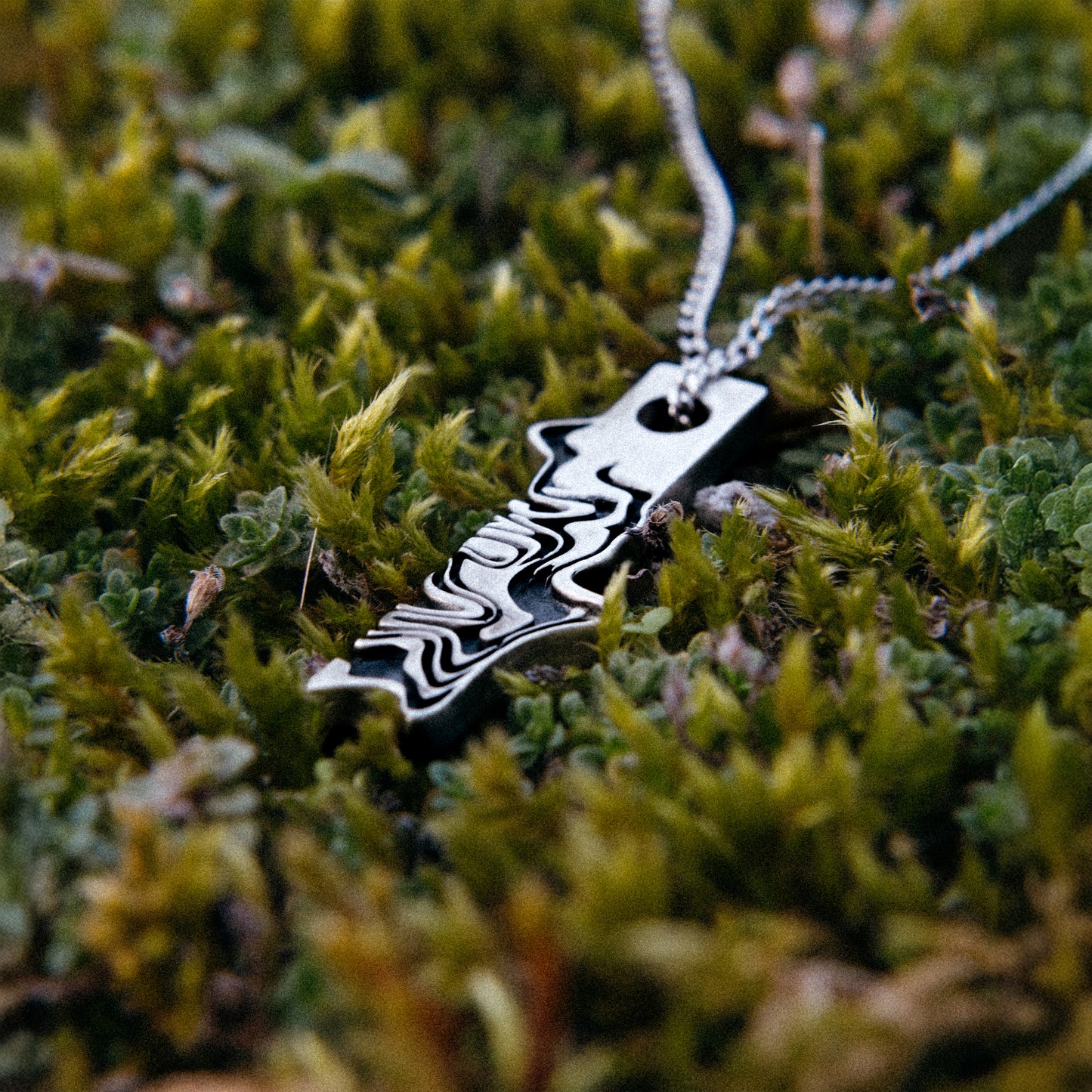 Solaque Tidal Motion handmade sterling silver pendant jewellery on grass