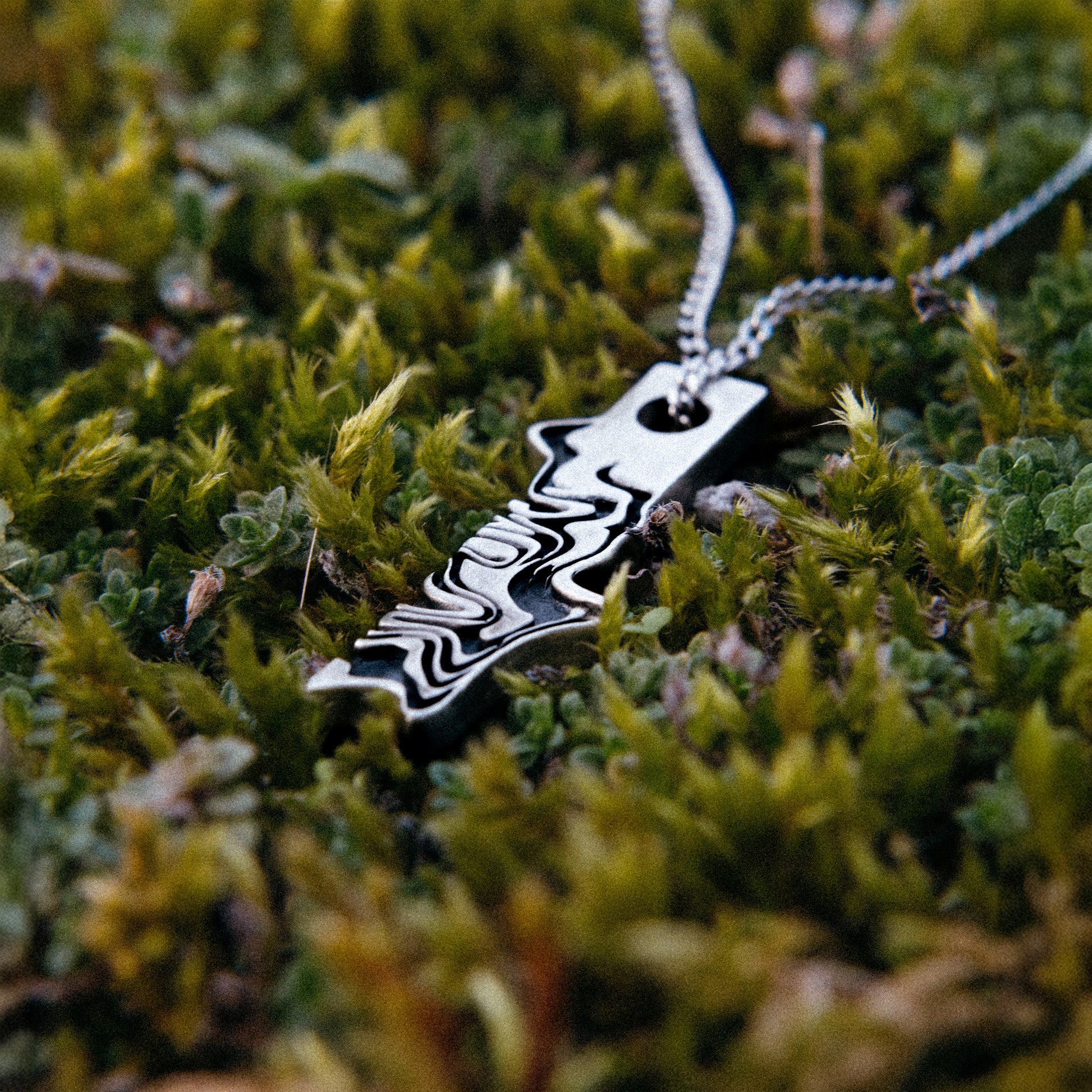Solaque Tidal Motion handmade sterling silver pendant jewellery on grass