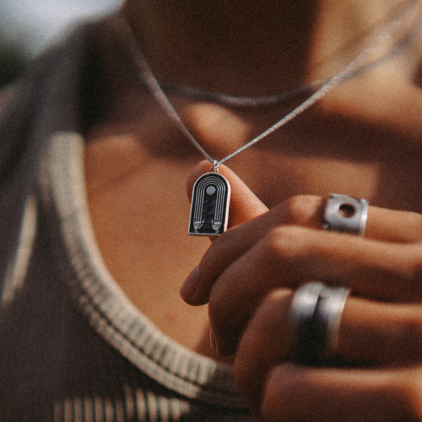 Solaque Crescent Hold handmade sterling silver pendant jewellery holding against hand 