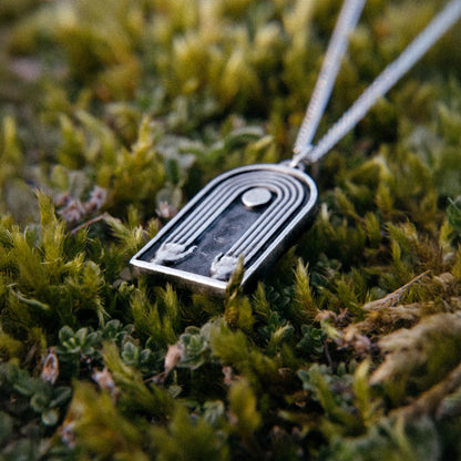 Solaque Crescent Hold handmade sterling silver pendant jewellery on grass