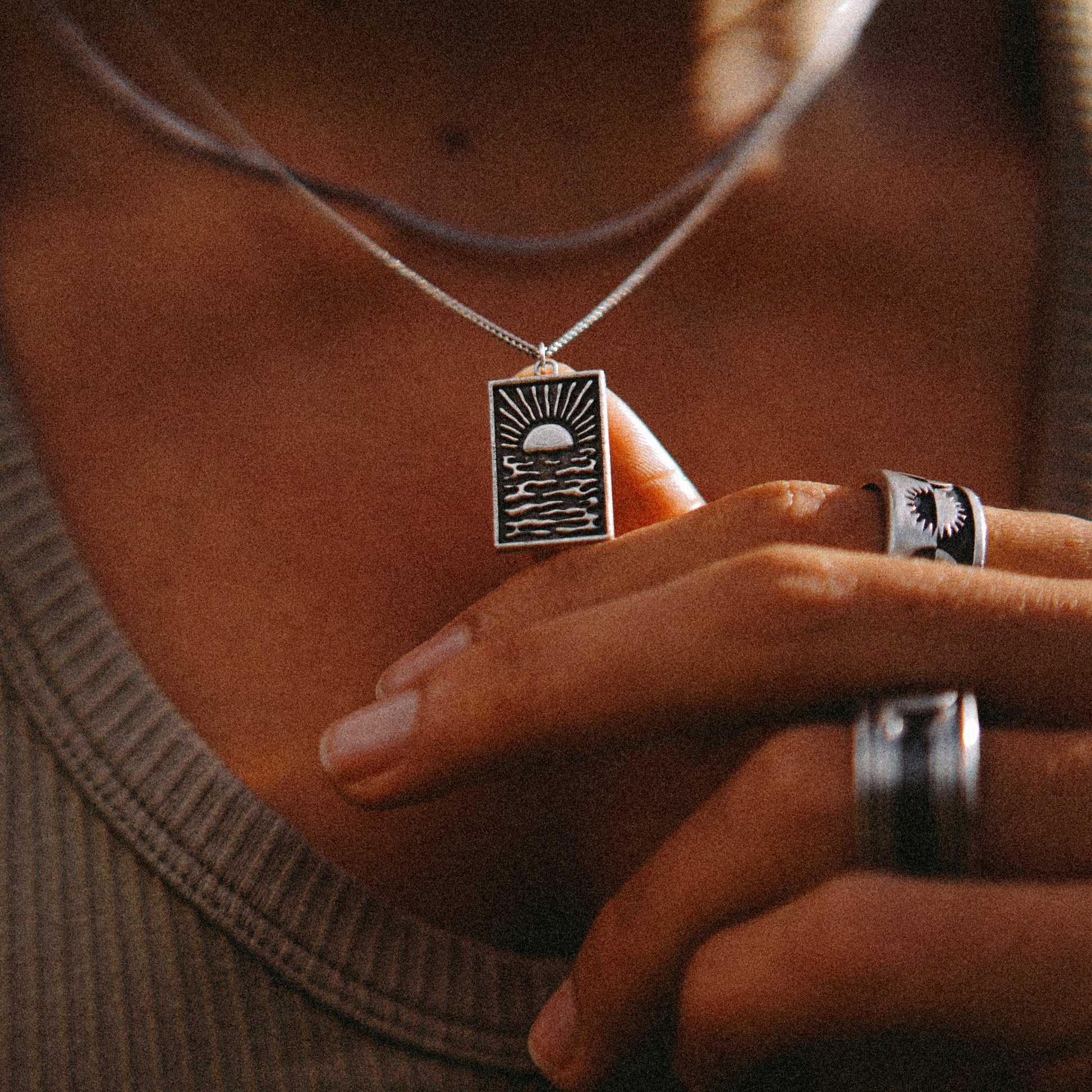 Solaque Echoes of Dusk handmade sterling silver pendant jewellery holding against hand