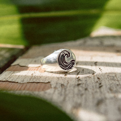 Solaque Ocean Drift handmade sterling silver wave design ring jewellery on a rustic wooden surface