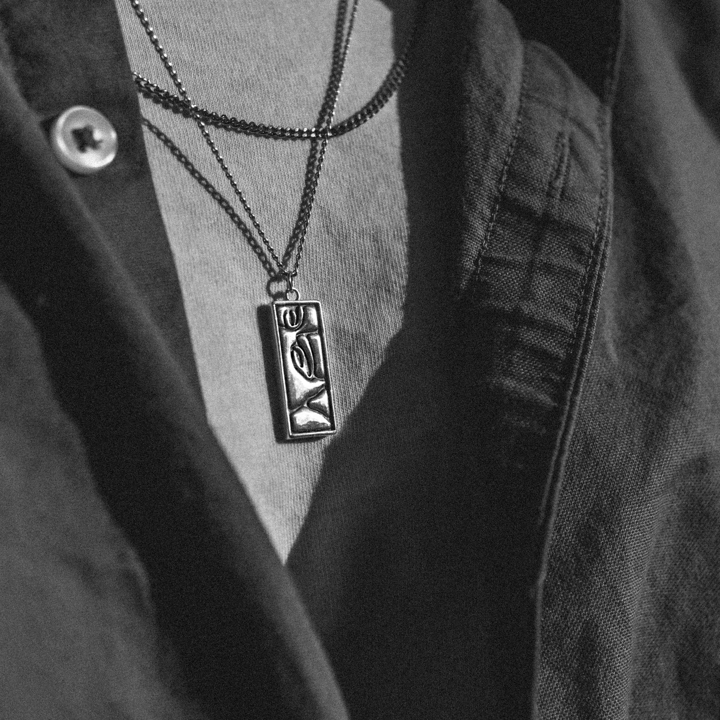 Solaque Silent Gaze handmade sterling silver face design pendant jewellery worn by a person