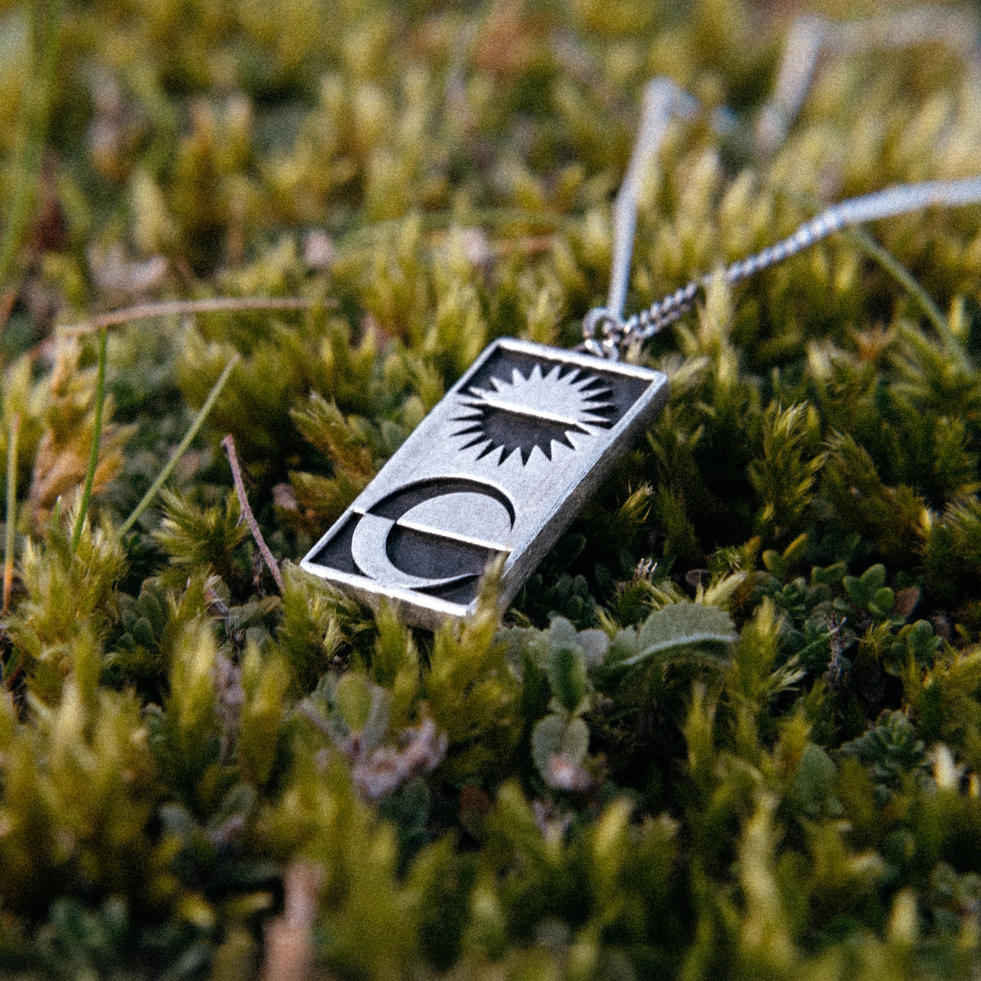 Solaque Solar Mirage handmade sterling silver pendant jewellery on grass