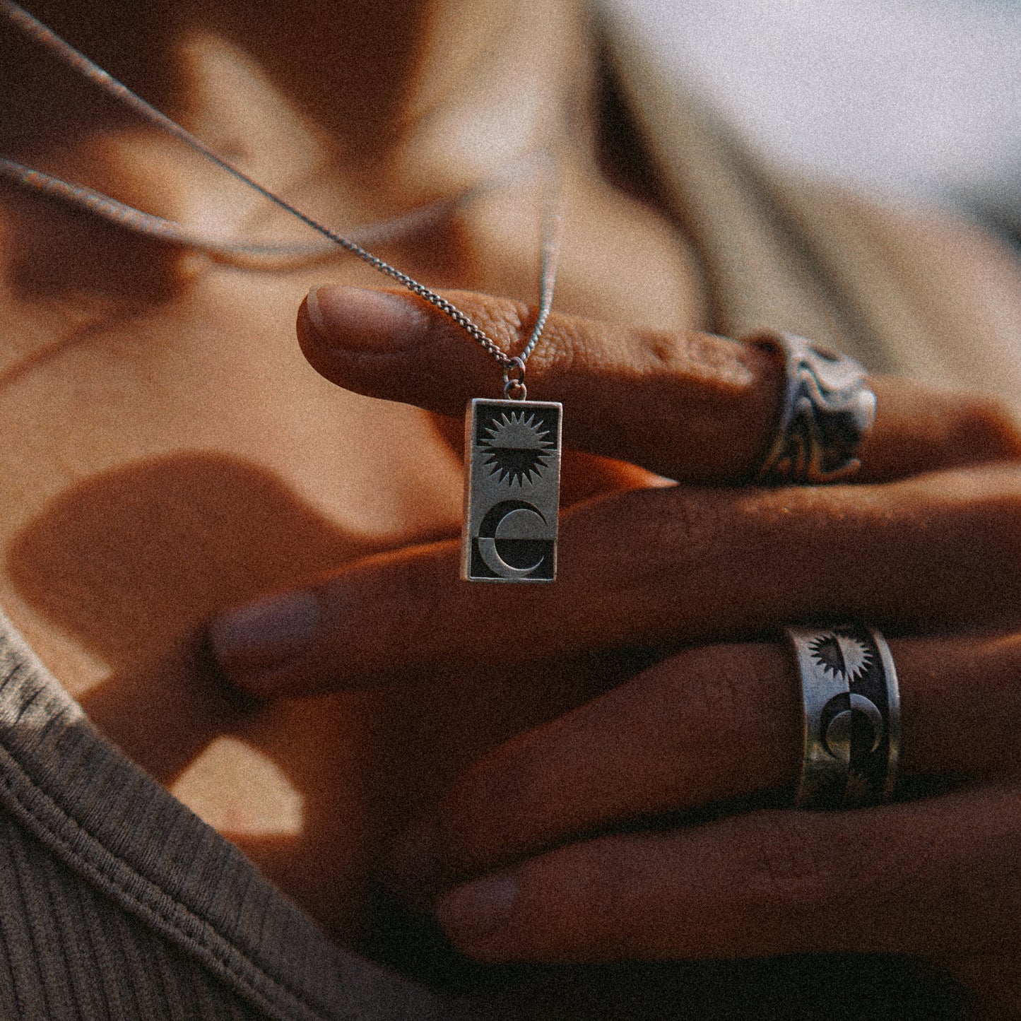 Solaque Solar Mirage handmade sterling silver pendant jewellery holding against hand 