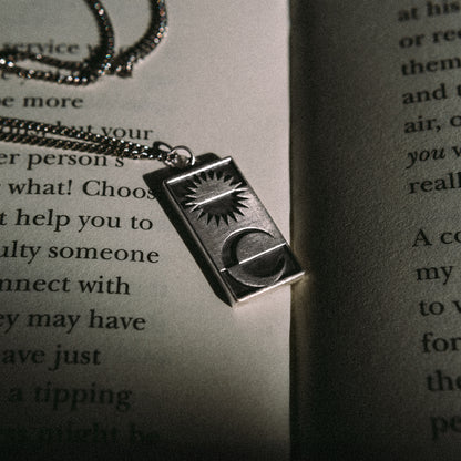 Solaque Solar Mirage handmade sterling silver pendant jewellery on book