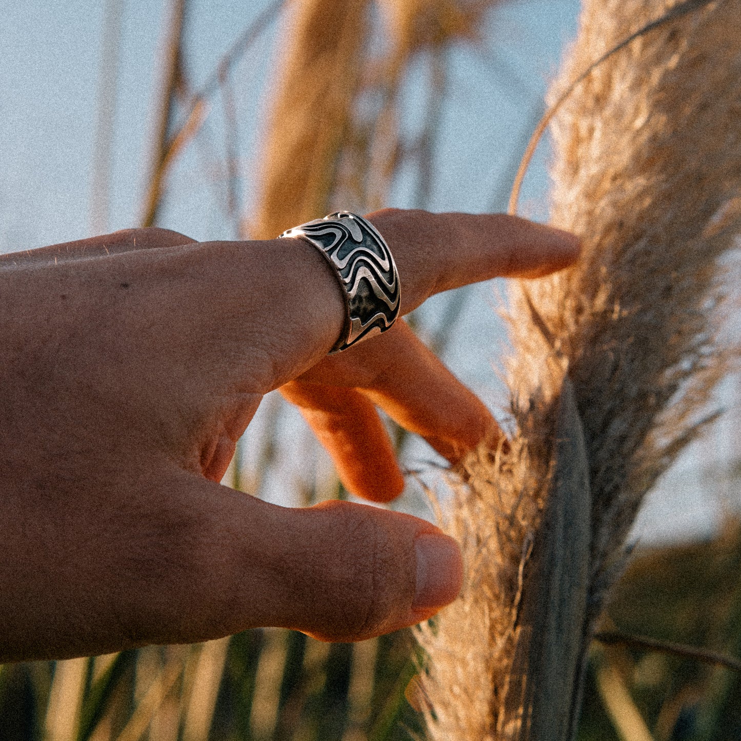 Solaque Tidal Motion handmade sterling silver ring jewellery against sky