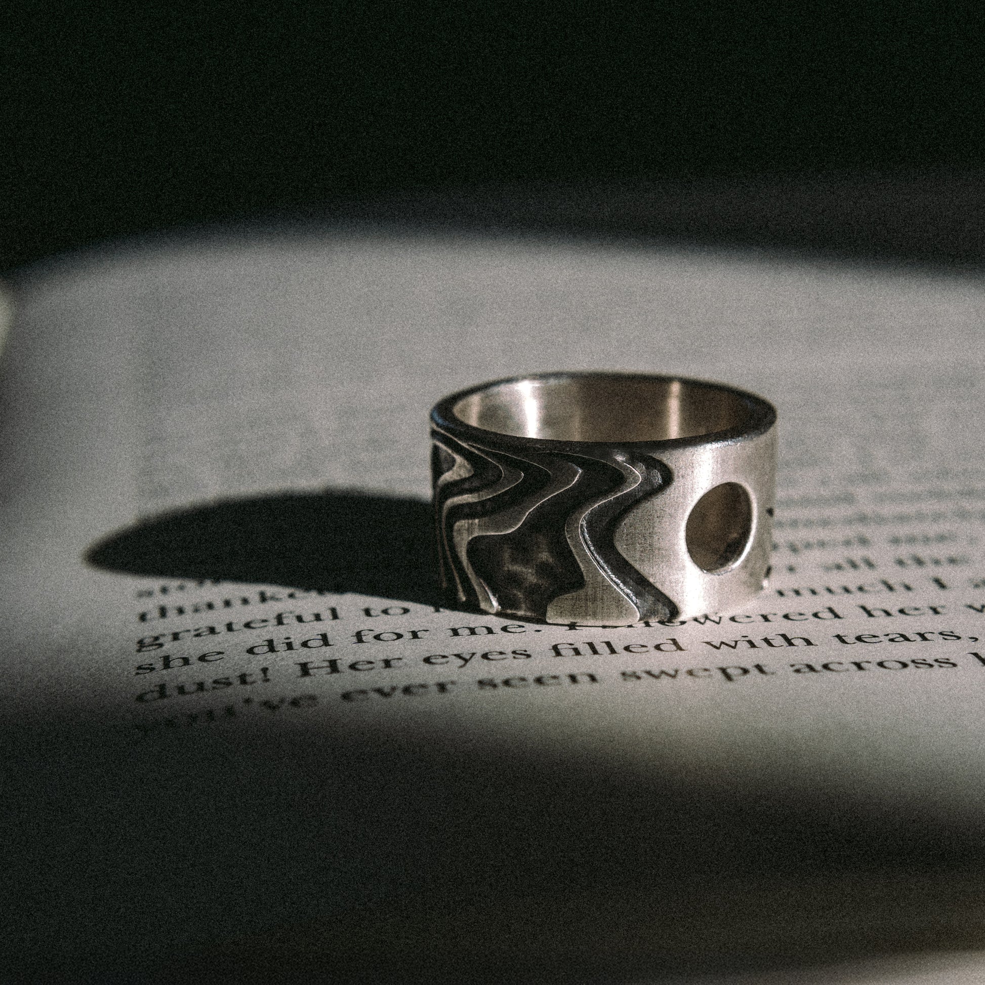 Solaque Tidal Motion handmade sterling silver ring jewellery on book