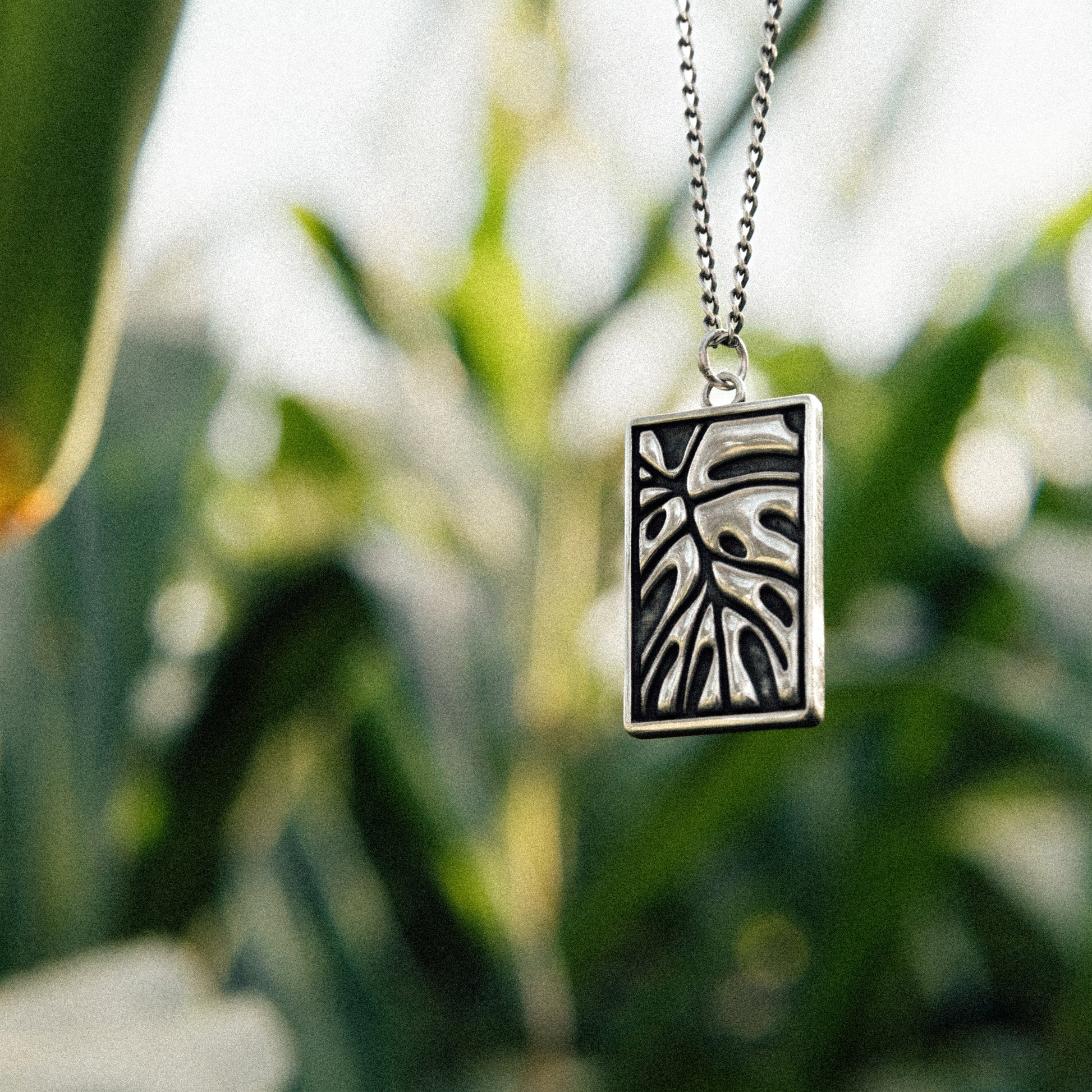 Solaque Veins of Monstera handmade sterling silver leaf design pendant jewellery against a natural background
