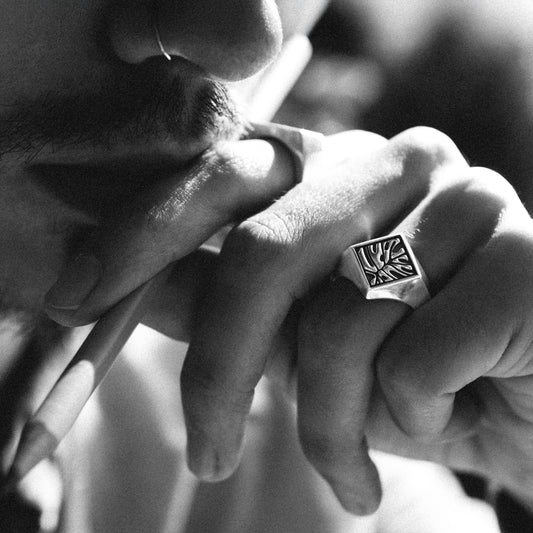 Solaque Veins of Monstera handmade sterling silver leaf design ring jewellery on hand, holding a pencil